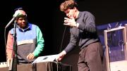 Stretchi creator Hugh Aynsley demonstrates his instrument on stage with collaborator Shannon Ladson.